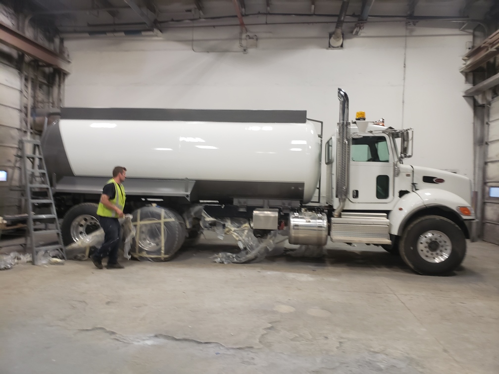 A water truck being unmasked for its final look over